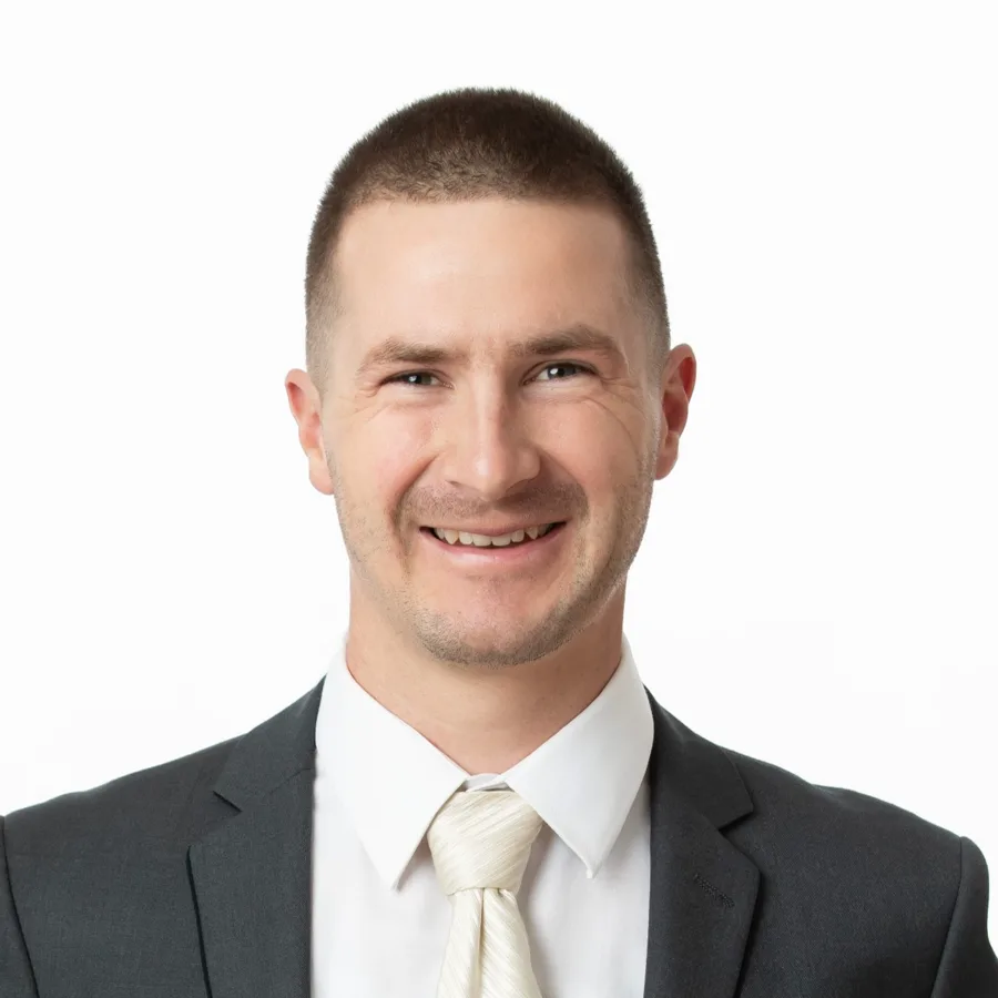 Justin Paupst-Wall in a dark suit, smiling